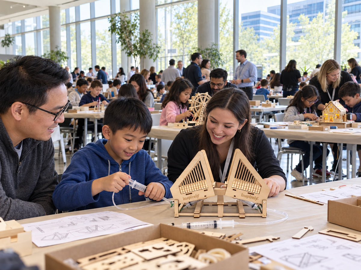 Families build Inspirely STEM kits at a company event.